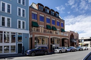 Fashion Coalition building, brick with green awnings located on Historic Main Street
