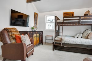 The third bedroom with a twin over full bunk bed, recliner, and flat screen TV.