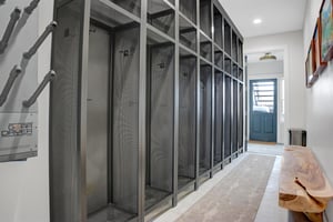 The lower level entrance leads an entry with plentiful floor to ceiling ski lockers that line the wall and boot dryers.