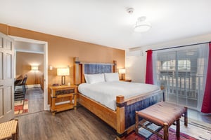 Resort Plaza 5024s main suite with a king size bed and gas burning fireplace.