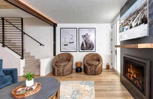 Two club chairs next to the the fireplace and flatscreen TV.
