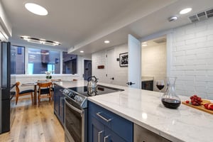 The spacious galley kitchen and a half bathroom.