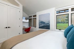 The spacious main suite with a desk nook and flat screen TV.