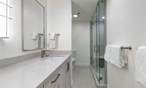 The en suite bathroom with two sink vanity and walkin shower.