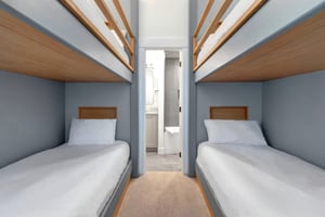 The third bedroom with two twin bunk beds and en suite bathroom.