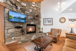 Beautiful stone fireplace, flat screen TV and cozy furnishings.