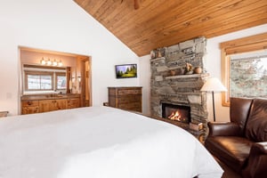 Stone gas fireplace in the main bedroom