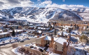 Copperbottom Inn with Park City Mountain Resort covered in snow behind it.