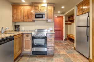 Your fully equipped kitchen with warm wood cabinets and granite counters.
