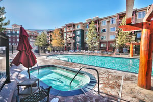 Pool deck with separate hot tub and plenty of poolside lounging.