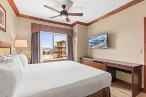 Unwind in your comfortable bedroom featuring a plush king bed, modern amenities, and mountain views from your private window.