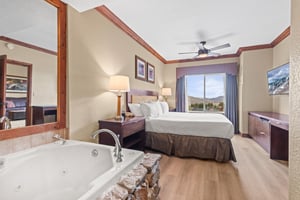 Relax in your spacious suite featuring a king bed, jetted tub, and serene mountain views through large windows.