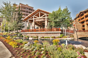 Westgate Park City exterior with water feature and wildflowers