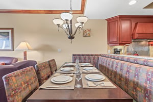 Your spacious dining area features elegant table settings and connects seamlessly to the fully equipped kitchen.