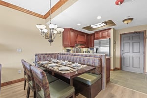 Your elegant dining area features a spacious booth and table perfect for family meals, with a fully equipped kitchen.