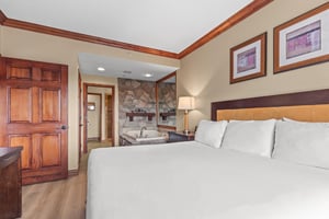 Relax in your spacious bedroom featuring a plush king bed and an elegant ensuite with stone fireplace and soaking tub.