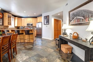 Relax in your spacious openconcept kitchen and dining area, featuring warm wood cabinets, granite countertops, and a cozy breakfast bar.