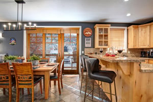 Your fully equipped kitchen and dining space features granite countertops, modern appliances, and a cozy breakfast bar.