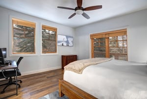 Rest peacefully in your bright bedroom with natural wood accents, ceiling fan for comfort, and work desk for convenience.