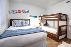 Your family bedroom features comfortable sleeping arrangements with both a cozy queen size bed and sturdy bunk beds.