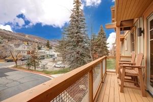 Relax on your private wooden balcony with comfortable seating and take in the mountain views.