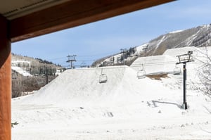 Snow Flower 65s view from the patio of Park City Mountains snowcovered terrain park and lift.