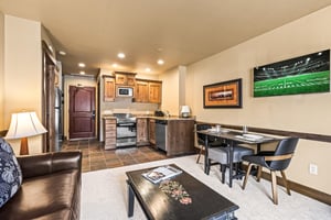 The open concept living area with efficient kitchen and dining table for two guests.