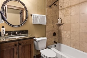 The en suite bathroom with a bathtub and shower combination.