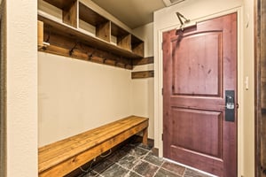 The entryway with a large bench and plenty of space to put outdoor gear.