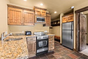 The efficient kitchen with oven, refrigerator, microwave, and dishwasher.