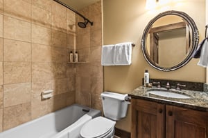 The guest bathroom with a bathtub and shower combination.