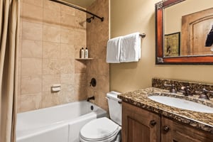 The en suite bathroom with a bathtub and shower combination.
