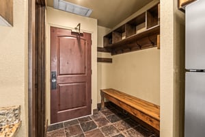 The entryway with a large bench and plenty of space to put outdoor gear.