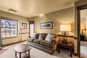 Settle into your spacious living room where plush seating and warm lighting create the perfect atmosphere.