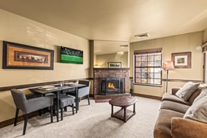 Unwind in your cozy living space while warm firelight dances across comfortable seating.