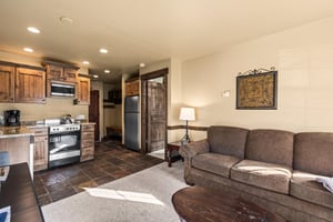 The open concept living area with efficient kitchen and dining table for two guests.