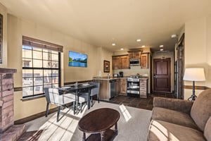 The open concept living area with efficient kitchen and dining table for two guests.