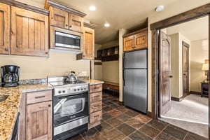 The efficient kitchen with oven, refrigerator, microwave, and dishwasher.