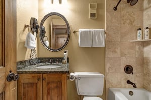 The en suite bathroom has a bathtub and shower combination.