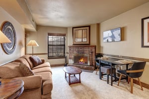 Cozy up in this charming living space where a crackling fireplace creates the perfect ambiance for your mountain getaway.