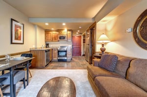 Your cozy openconcept space combines a fully equipped kitchen with warm wood cabinets and a stylish dining area.