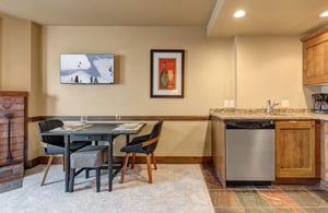 Your cozy openconcept space combines a fully equipped kitchen with warm wood cabinets and a stylish dining area.