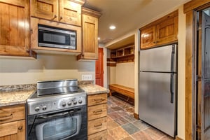 Your fully equipped kitchen with warm wood cabinets and granite counters.