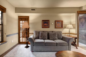 Settle into your elegant living room where rich wood details and plush gray seating create the perfect retreat.