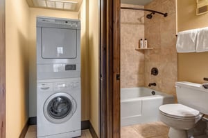 Your bathroom features a relaxing tubshower combo with warm stone tiles, while the convenient inunit washer and dryer.