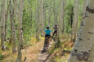 Mountain biking through the aspen trees at Park City Mountain.