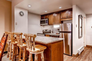 Breakfast bar seating for 4 with a full kitchen.