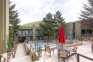 Take a refreshing dip in the pool or relax under the umbrella at the table and chairs.