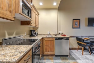 Your fullyequipped kitchen awaits with warm wood cabinetry, granite countertops, and stainless steel appliances.