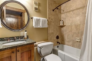 Step into your private spalike retreat with luxurious travertine tiles and rustic mountain charm.